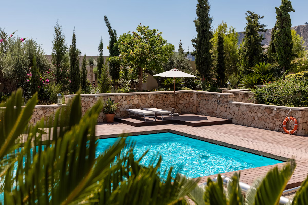 Luxury inground swimming pool with crystal clear water and custom stonework surround in Westchester County.